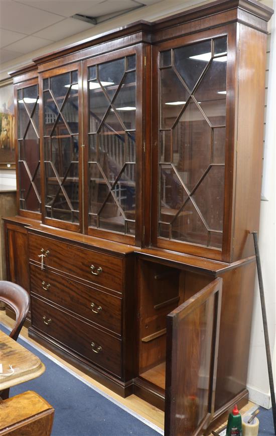 A Georgian style mahogany breakfront glazed bookcase with three drawers and cupboard to base W.232cm H.228cm